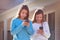 Sister twins having fun with technology smartphone