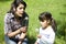 Sisters blowing dandelions