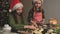 Sisters cutting figures from gingerbread dough