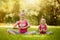 Sisters doing exercise outdoors. Healthy lifestyle