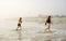 Sisters enjoying time on beautiful foggy beach.