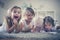 Sisters have play with baby brother in living room.