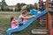 Sisters having fun on a slide together