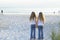 Sisters holding hands on the beach