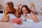 Sisters laughing out loud after watching comedy with sibling