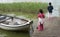 Sisters palying in the nature with a boat