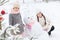 Sisters playing with a snowman with pink knitted scarf