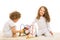 Sisters playing with wooden toy home