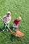 Sisters raking up the cut grass