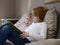 Sisters Reading Book On Bed