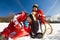 Sisters in snow on toboggan