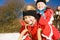 Sisters in snow on toboggan