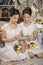 Sisters in vintage white dress with a bouquet of yellow roses