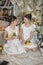 Sisters in vintage white dress with a bouquet of yellow roses