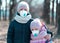 Sisters wearing protective masks in park