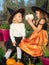 Sisters in witch hats playing with pumpkins