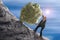 Sisyphus metaphor man rolling huge rock ball up hill