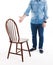 Sit down please. A man in casual style wear shows wooden rustic chair. Man and chair isolated on white background.