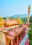 Sitagu International Buddhist Academy pagoda from above with a view on lush greenery of Sagaing Hill