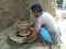 sitalpur village asansol West Bengal 26 may 2020 a Potter making flower pot on potter& x27;s wheel with aud wall on background