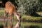 Sitatunga antelope drinking from a pond