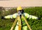 Site engineer doing level survey using auto level fitted on top of the wooden tripod and giving an ok sign