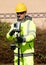 Site engineer surveyor checking points coordinates by placing pogo with prism and controller above  and receiving coordinates