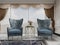 A sitting area in the bedroom with two comfortable designer blue armchairs with a gold pattern and a gilded table with a vase of