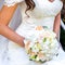 Sitting Bride holding a beautiful wedding bouquet