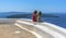 Sitting on the edge of Skaros Rock surveying the volcanic island of Nea Kameni, Santorini