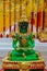 Sitting Emerald Buddha golden statue in the wat thai temple