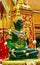 Sitting Emerald Buddha golden statue in the wat thai temple