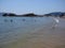 Sitting places and people at sandy beach on bay of ACAPULCO city in Mexico with calm Pacific Ocean