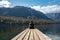 Sitting on a small jetty and enjoying the view on the landscape of lake Bohinj in the Triglav National Park, The Julian Alps of