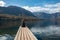 Sitting on a small jetty and enjoying the view on the landscape of lake Bohinj in the Triglav National Park, The Julian Alps of