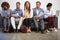 Sitting and waiting. Full length shot of a group of businesspeople sitting in a line on a sofa.