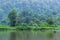 Situ Gunung Lake in the middle of Gede Pangrango National Park, Indonesia in the morning. Reflection of trees on water.