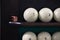 Six billiard balls on the shelf stand and chalk whiten the tip of the cue. for playing Russian Billiards.