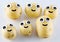 Six cheerful little potatos with eyes and smiles