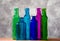 Six colored bottles and their glass transparency.