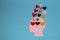 six colorful paper hearts in a pink paper head, more hearts floating above the head come out of it