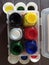 Six colour botals on the plastic square box with botals caps black yellow red white blue and green