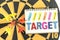 Six dart in bullseye with words target on the notebook with hand