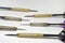 Six darts needles closeup. Sharp Steel. Brass and stainless steel barrels