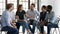 Six employees sit on chairs discussing taking part in seminar