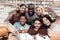 Six ethnic students, mixed race, indian, asian, african american and white surrounded with books at library.