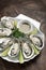 Six fresh oysters with lime wedges and citrus sauce