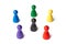Six game figures standing in a circle with a black figure in the middle. Symbol for a color wheel or a group of people