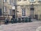 Six green rubbish bins in a line