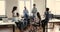 Six multiethnic staff members gather in coworking during morning briefing